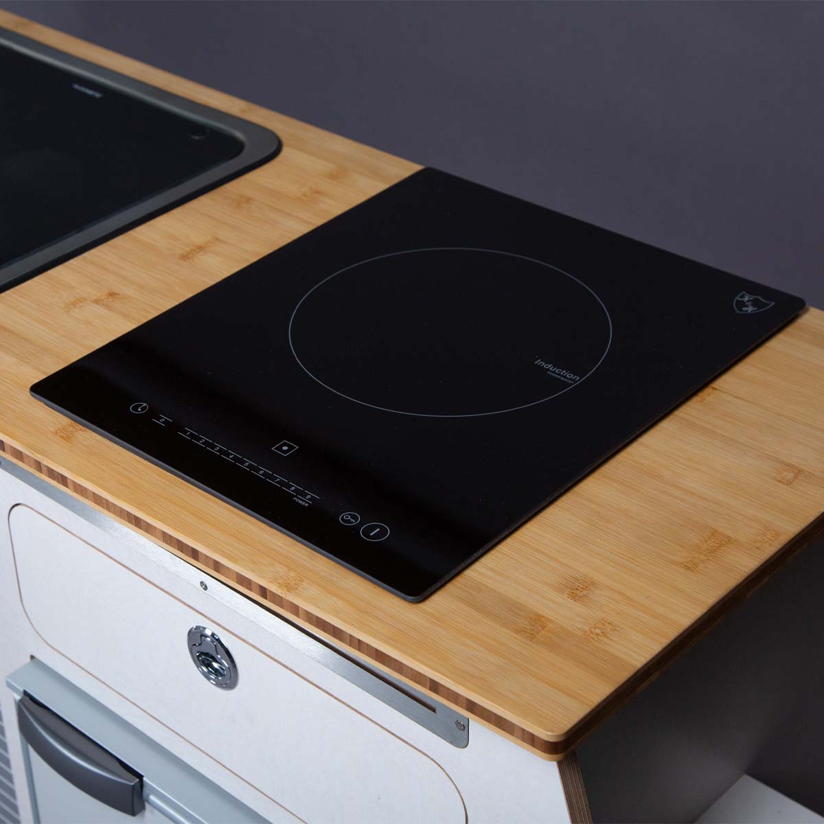 Sleek K&H INS-2401-X induction cooktop with a black glass surface, touch controls, and a compact, modern design.